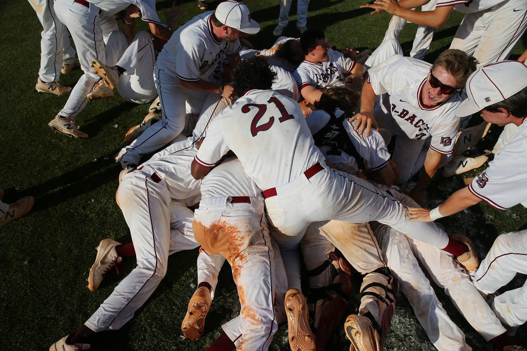 Desert Oasis celebrate their win over Basic in the Desert Region championship baseball game ...