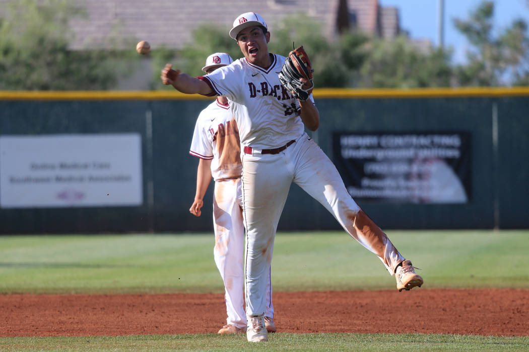 Desert Oasis’ Aaron Roberts (25) throws to first base for an out and to end the game a ...