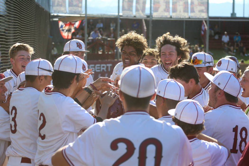 Desert Oasis celebrate a two run homer by Campbell Holt (16) against Basic in the Desert Reg ...