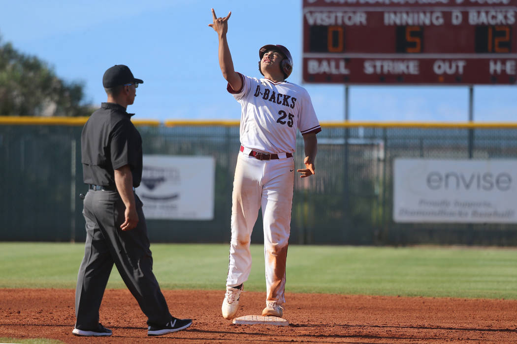 Desert Oasis’ Aaron Roberts (25) reacts after hitting a double for a single RBI agains ...