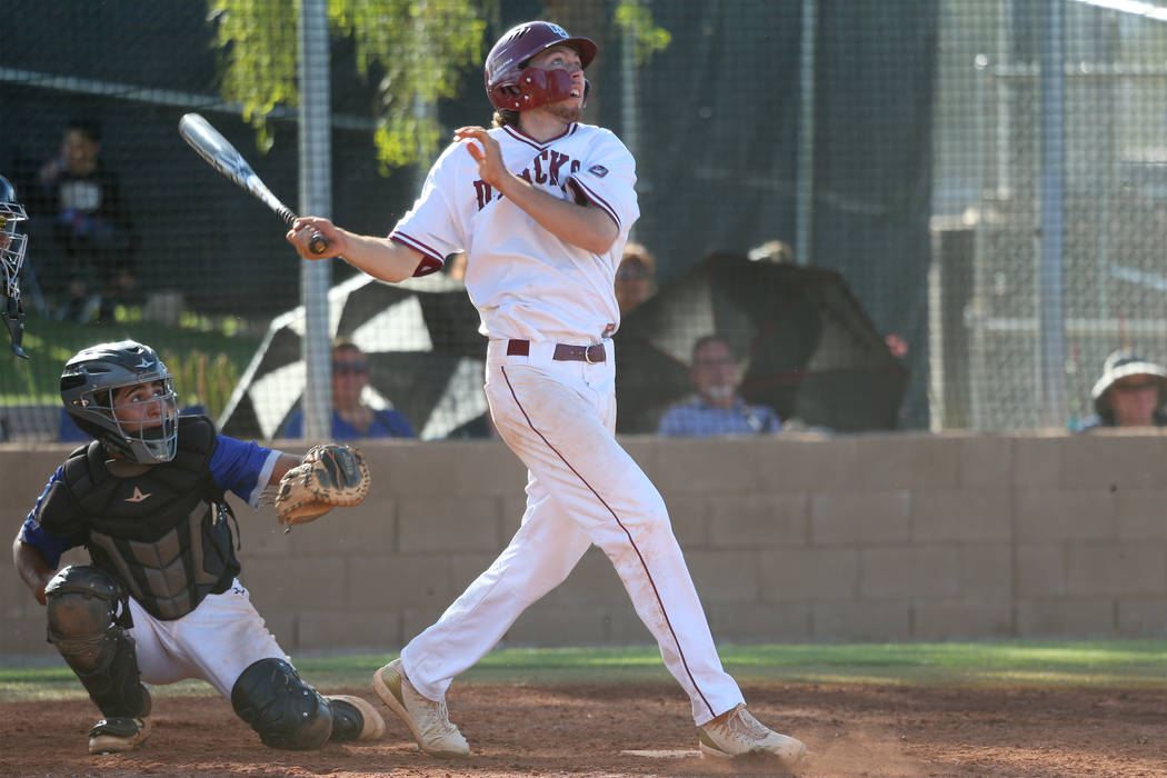 Desert Oasis’ Campbell Holt (15) watches the ball leave for a solo homer against Basic ...