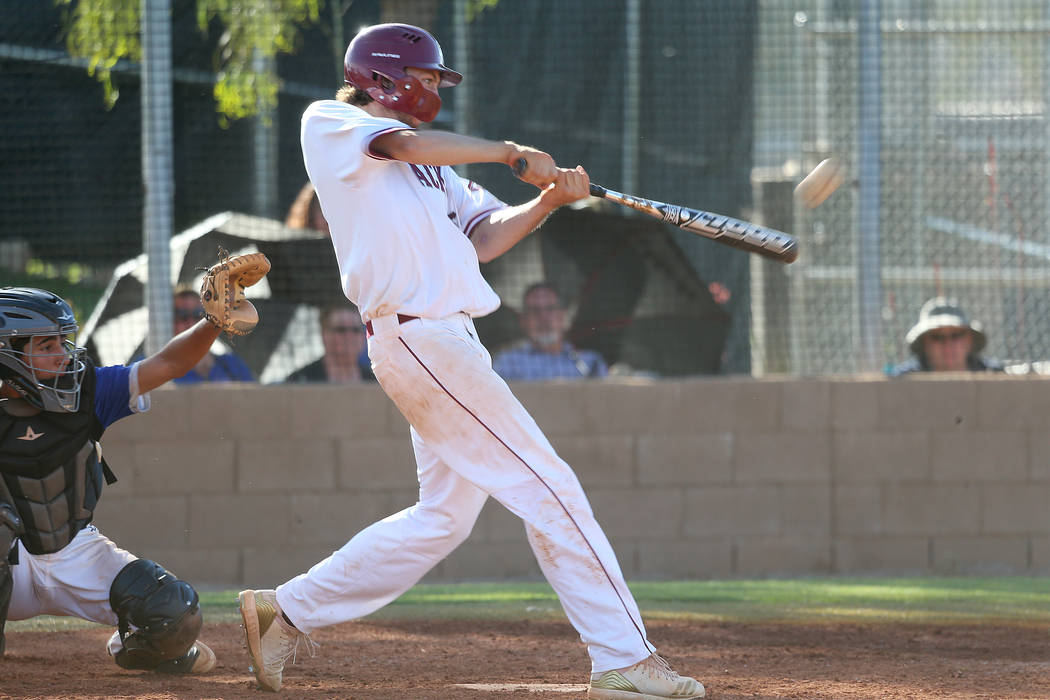 Desert Oasis’ Campbell Holt (15) his a solo homer against Basic in the Desert Region c ...