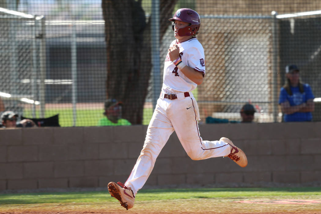 Desert Oasis’ Parker Schmidt (4) runs home for a run against Basic in the Desert Regio ...