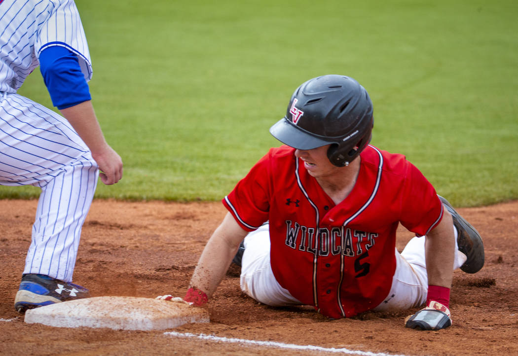 Las Vegas’ Joel Lindahl (5) dives back to first base to beat the tag versus Reno durin ...