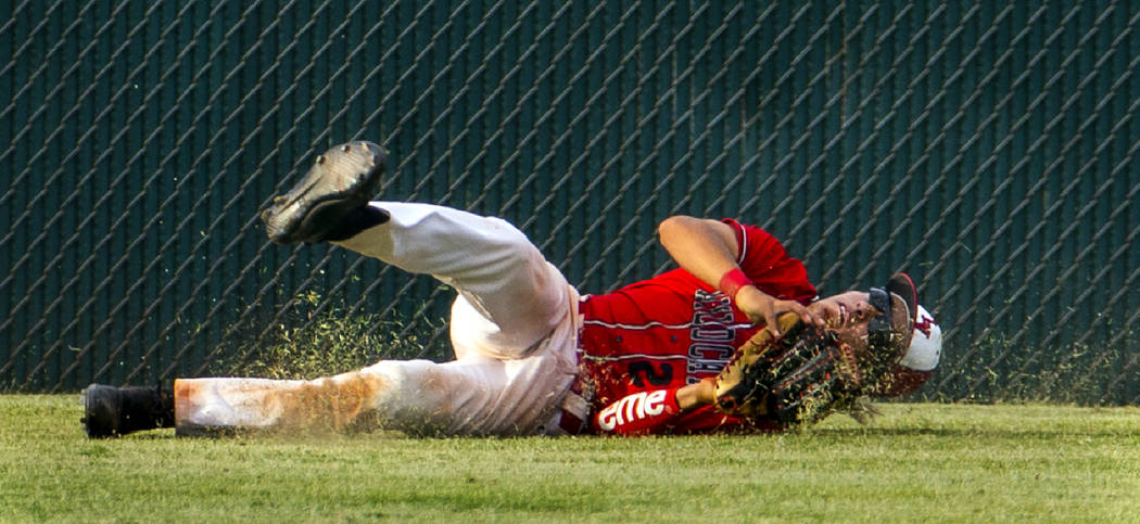 Las Vegas’ Dalton Silet (23) secures a long, fly ball catch in the outfield after a ci ...