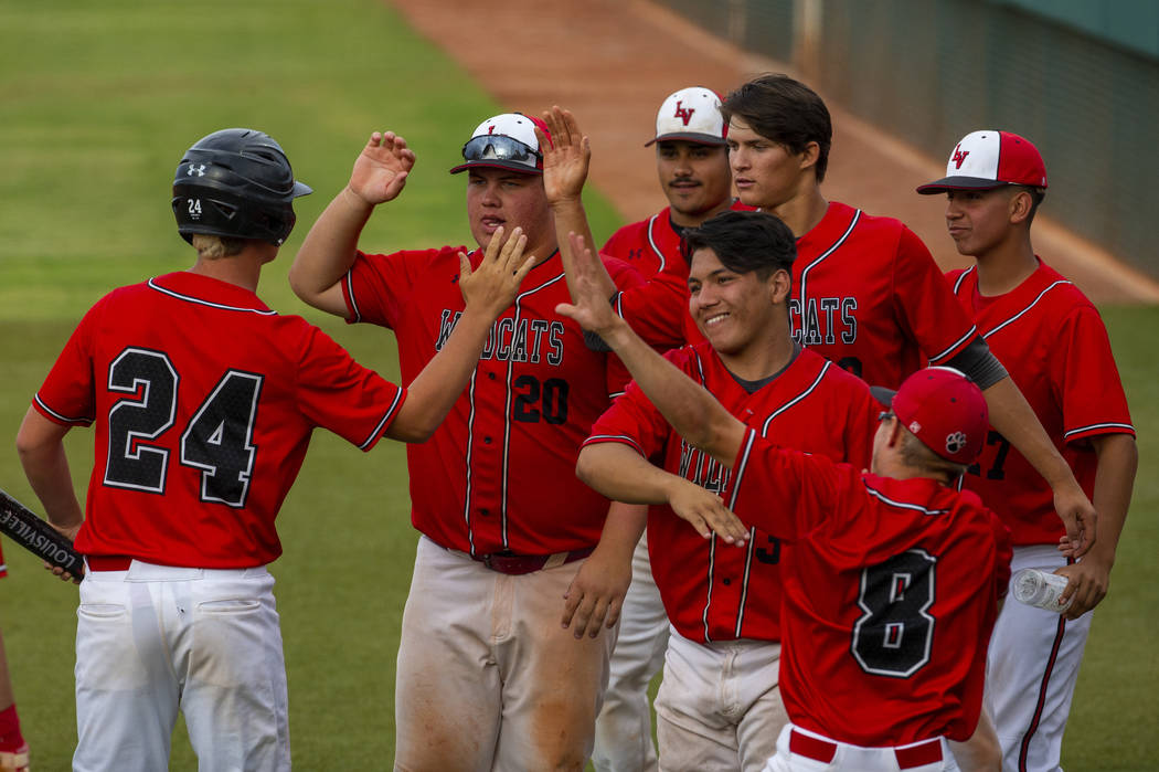 Las Vegas players celebrate a run by teammate Brady O’jeda (24) versus Reno during the ...