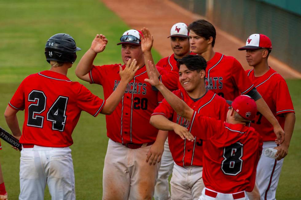 Las Vegas players celebrate a run by teammate Brady O’jeda (24) versus Reno during the ...