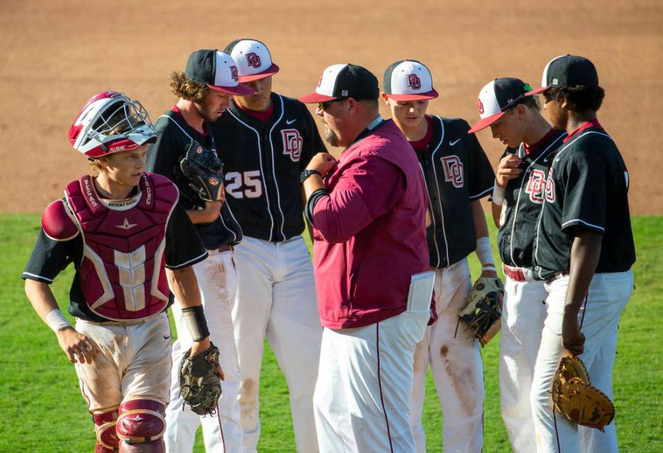 Desert Oasis’ players come together on the mound with their coach versus Reno during t ...