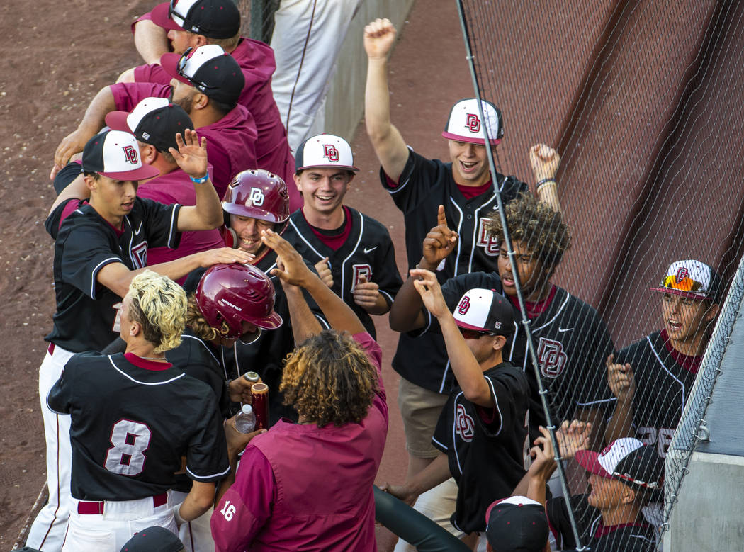 Desert Oasis players celebrate another run over Reno during their Class 4A state baseball to ...