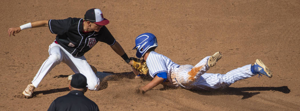 Desert Oasis’ Zac Czerniawski (8) tags out Reno’s Gunner Gouldsmith (8) attempti ...