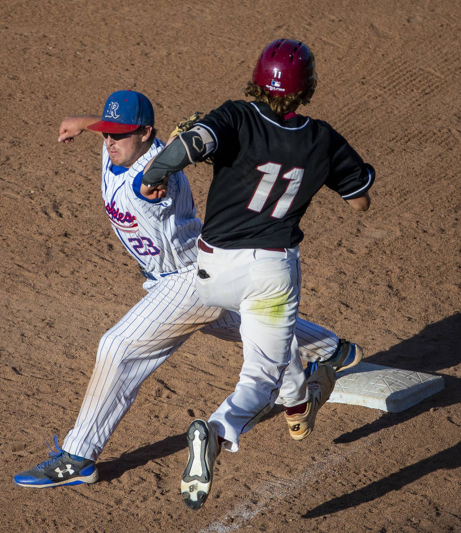 Reno’s Ryan Hess (23) attempts a tag on Desert Oasis runner Josh Sharman (11) but will ...