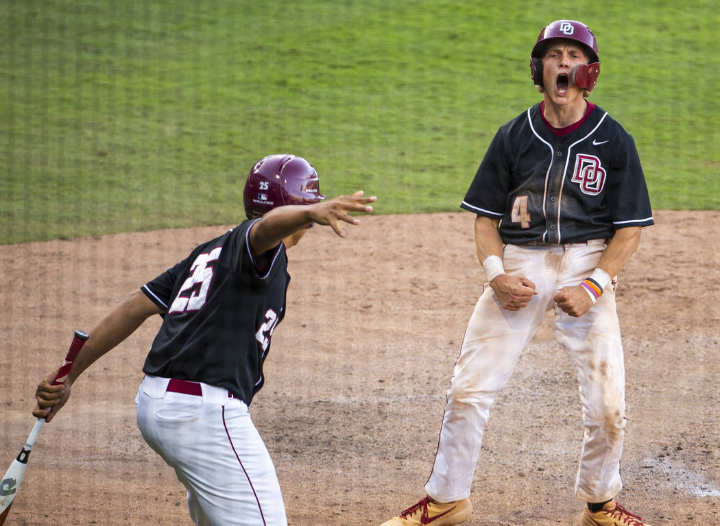 Desert Oasis’ Parker Schmidt (4) celebrates another run over Reno during their Class 4 ...