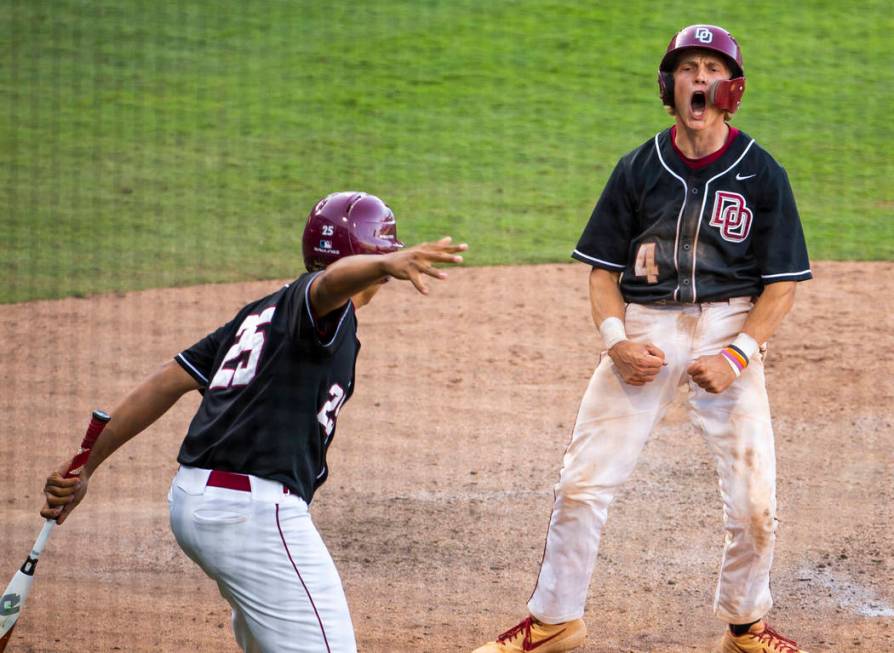 Desert Oasis’ Parker Schmidt (4) celebrates another run over Reno during their Class 4 ...