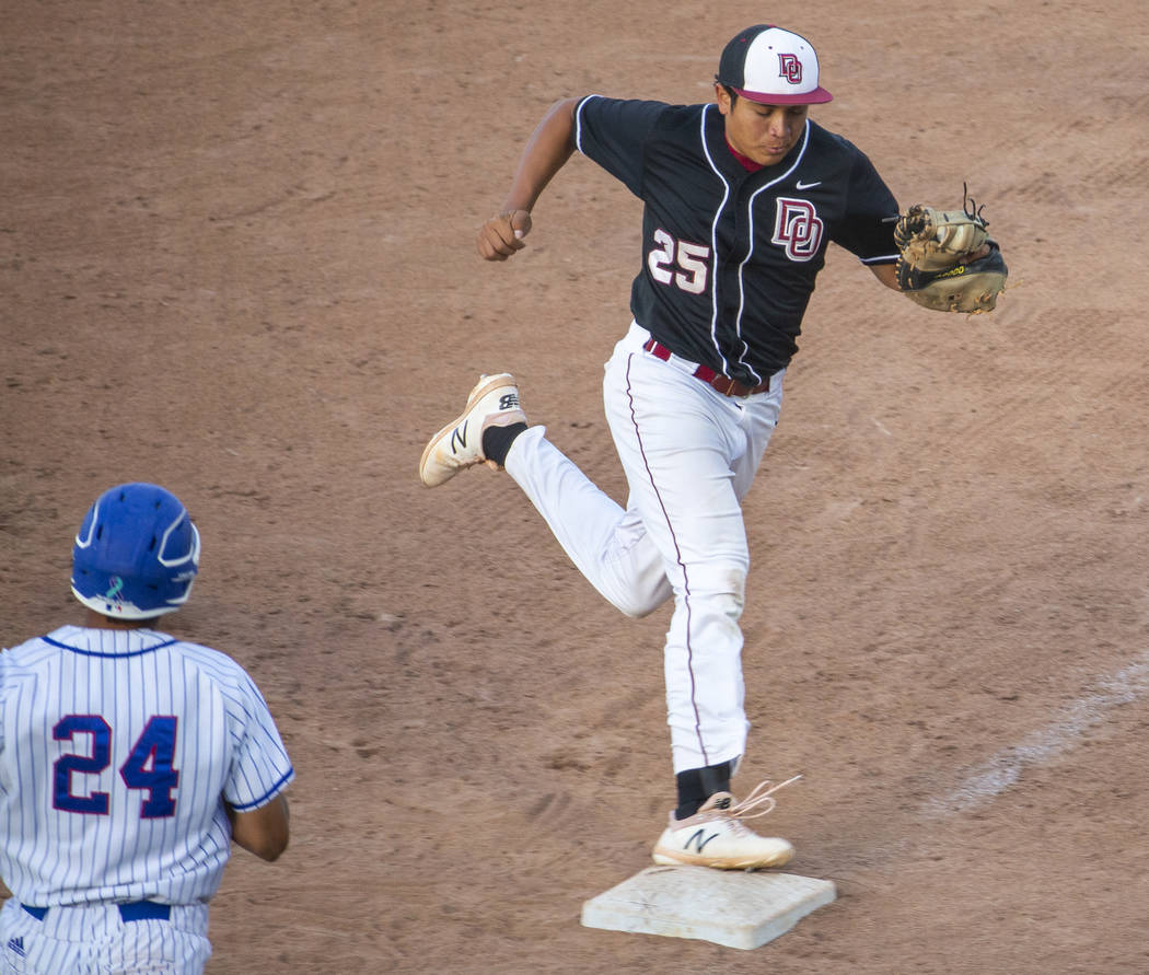 Desert Oasis’ Aaron Roberts (25) makes the final out at first base over Reno’s S ...