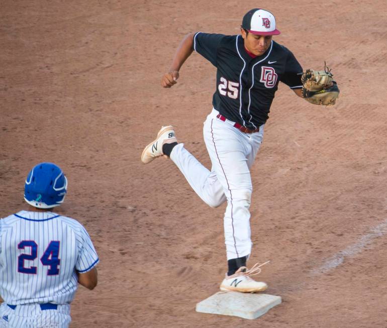 Desert Oasis’ Aaron Roberts (25) makes the final out at first base over Reno’s S ...