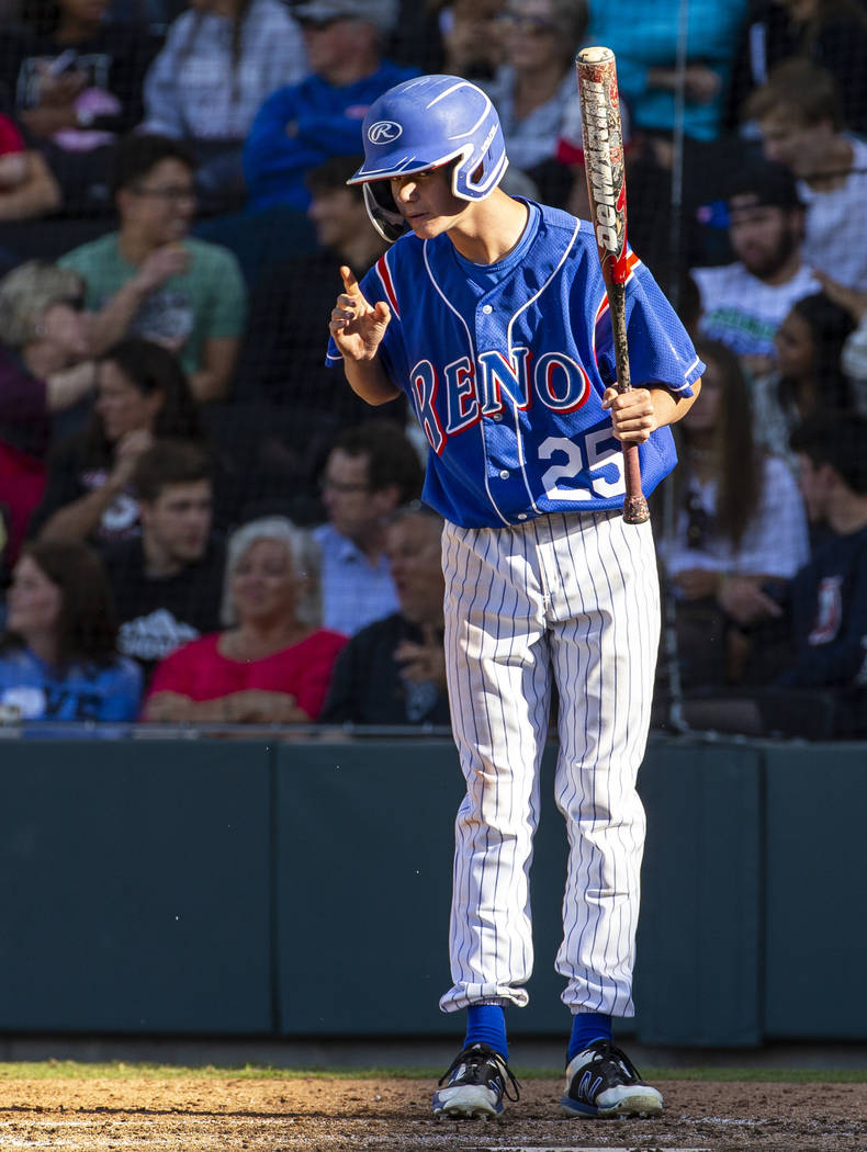 Reno batter Garryson Grinsell (25) takes direction from his coach versus Desert Oasis in the ...