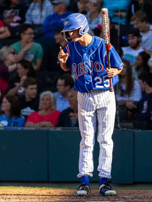 Reno batter Garryson Grinsell (25) takes direction from his coach versus Desert Oasis in the ...