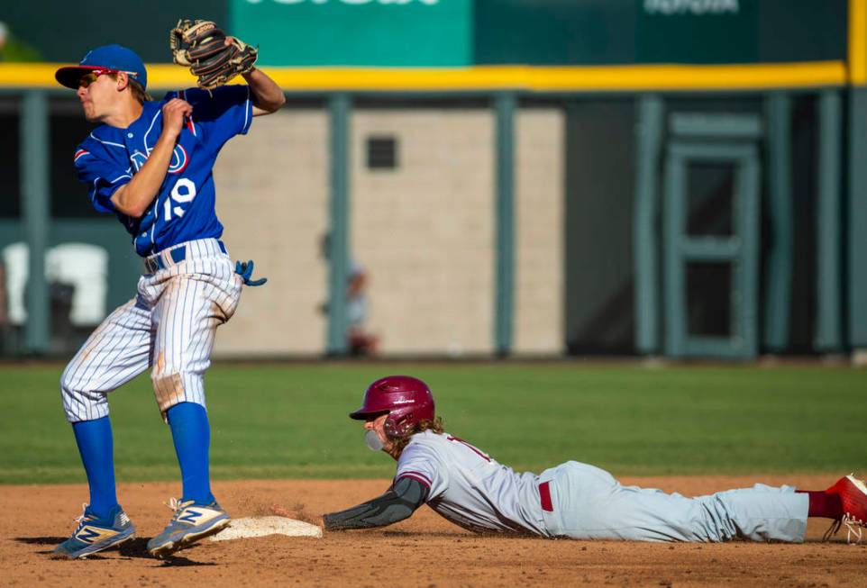 Reno’s Cade Grogan (19) saves an overthrow at second base while Desert Oasis’ Jo ...