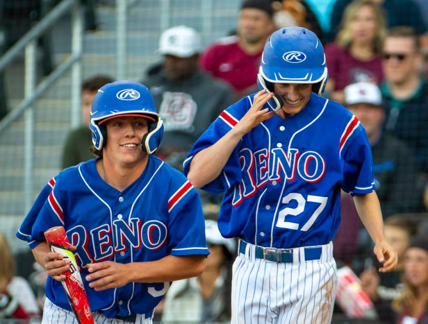 Reno’s Drue Worthen (5) and Jake Novacek (27) look to their teammates as they celebrat ...