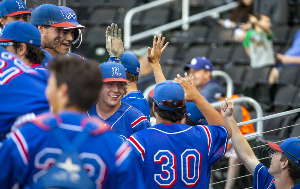 Reno players celebrate their game-winning runs in the sixth inning versus Desert Oasis durin ...