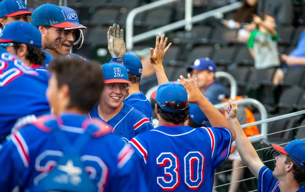 Reno players celebrate their game-winning runs in the sixth inning versus Desert Oasis durin ...