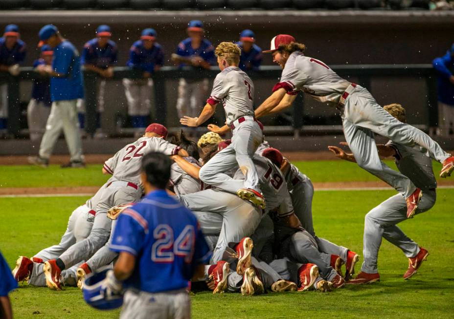 Desert Oasis players celebrate their win over Reno 9-1 during the tie-breaker game of their ...