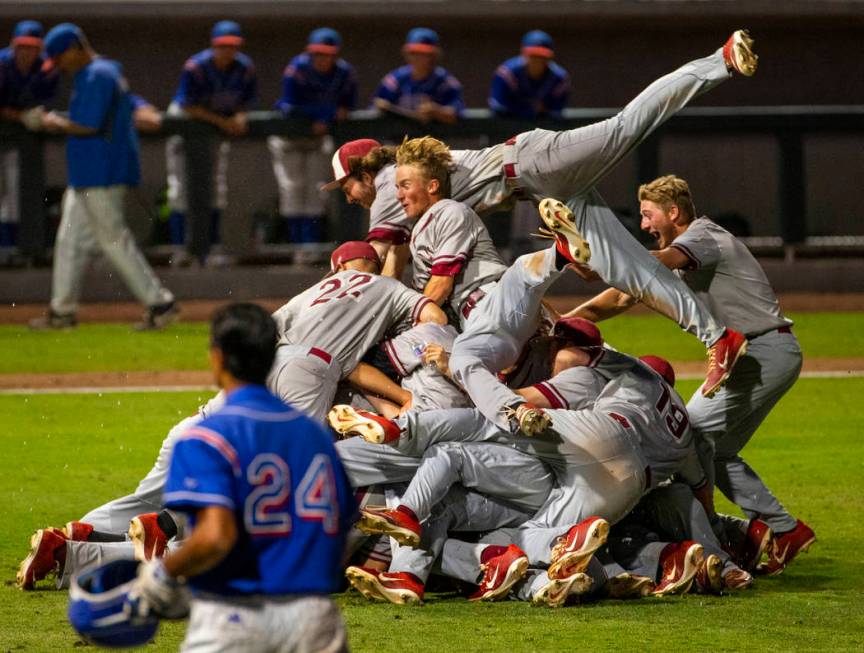 Desert Oasis players celebrate their win over Reno 9-1 during the tie-breaker game of their ...