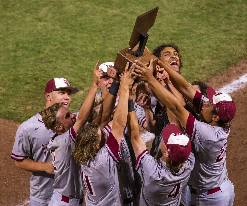 Desert Oasis players celebrate their trophy after defeating Reno 9-1 during the tie-breaker ...