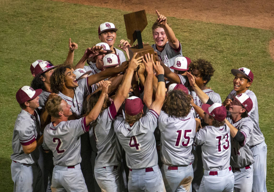 Desert Oasis players celebrate their trophy after defeating Reno 9-1 during the tie-breaker ...