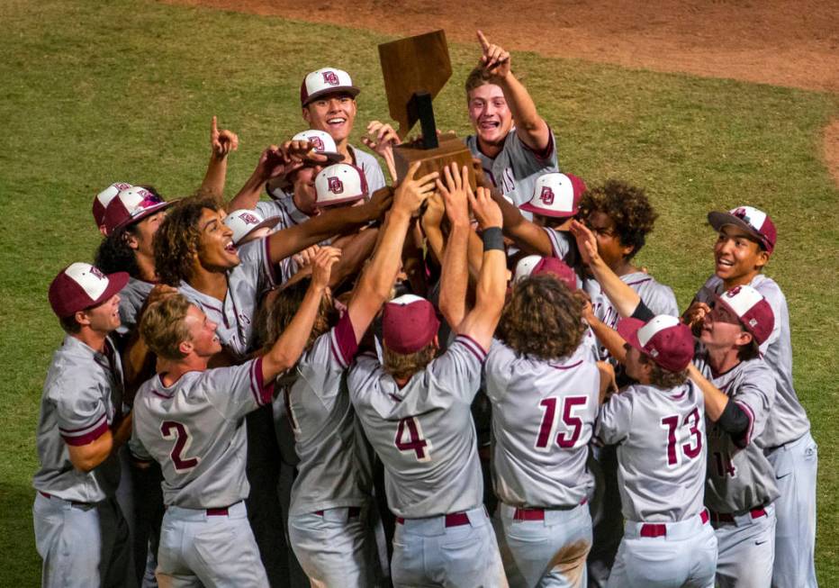 Desert Oasis players celebrate their trophy after defeating Reno 9-1 during the tie-breaker ...