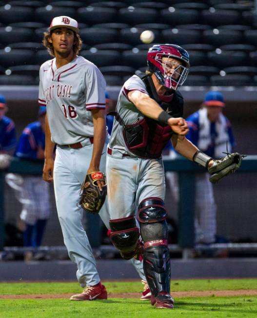 Desert Oasis pitcher DJ Jefferson Jr. (16) looks on as catcher Parker Schmidt (4) makes a th ...