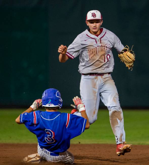 Reno runner Garrett Damico (3) arrives late at second base as Desert Oasis’ Colby Smit ...