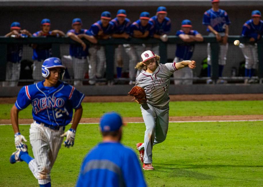 Desert Oasis pitcher Josh Sharman (11, right) throws the final out to first base ahead of Re ...