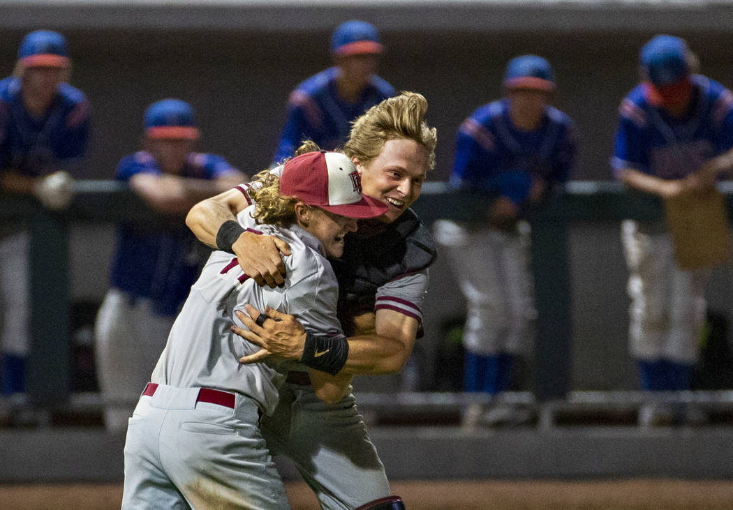 Desert Oasis pitcher Josh Sharman (11) celebrates their win with catcher Parker Schmidt (4) ...