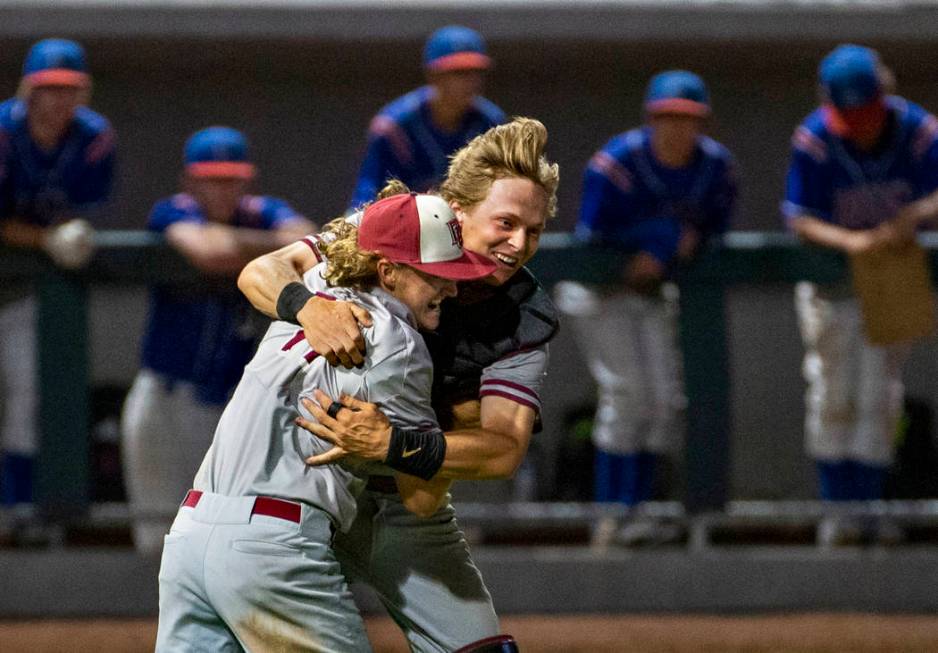 Desert Oasis pitcher Josh Sharman (11) celebrates their win with catcher Parker Schmidt (4) ...