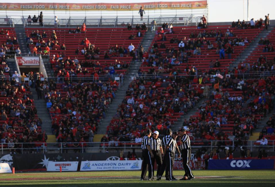 Referees meet at midfield during a tv timeout during the UNLV Nevada football game at Sam Boyd ...