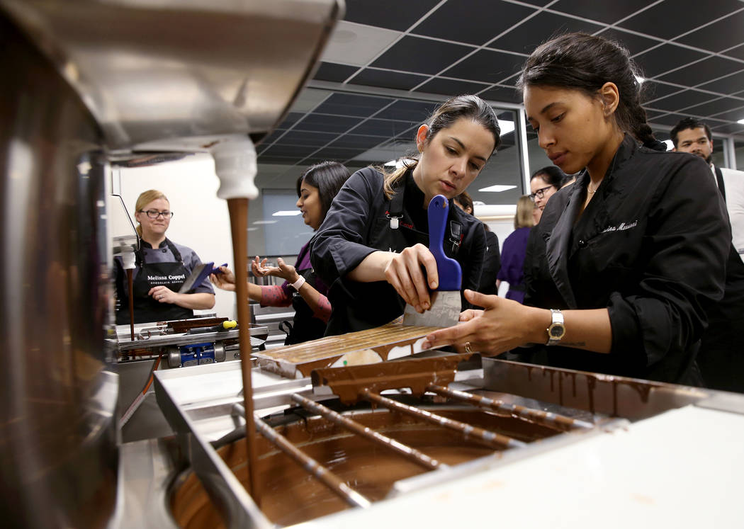 Melissa Coppel, left, works with Cesarina Mezzoni of San Diego at her Las Vegas chocolate schoo ...