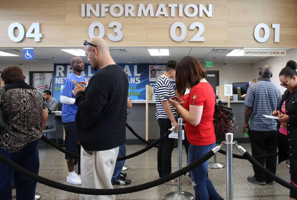 Customers wait in line the at the East Sahara office of the Department of Motor Vehicles, May 1 ...