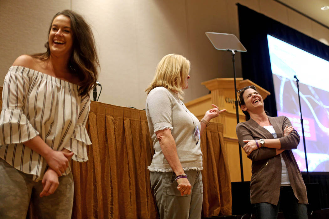 Katie Boer, from left, Carolyn Leavitt, and Melanie Lewis laugh while participating in an exerc ...