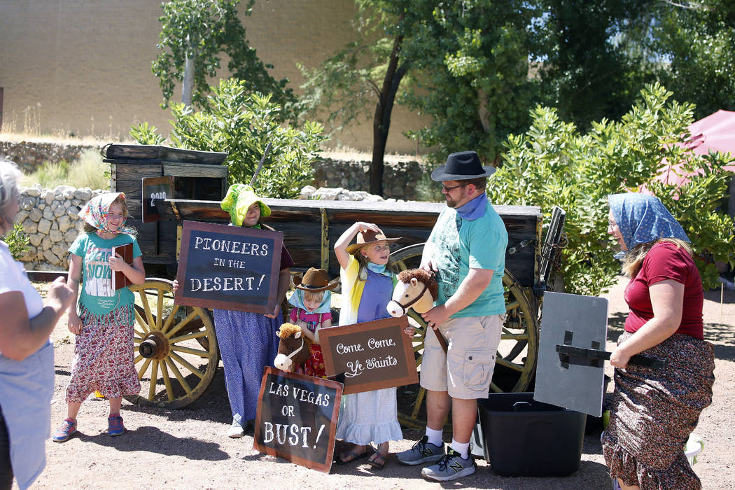 A family gets ready for the photo booth during Pioneer Day at Old Mormon Fort in Las Vegas, Sat ...