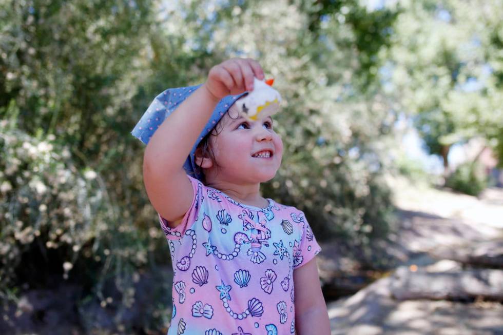 Addy Bartlett, 4, visiting family in Las Vegas, holds her plastic duck used in the duck race du ...