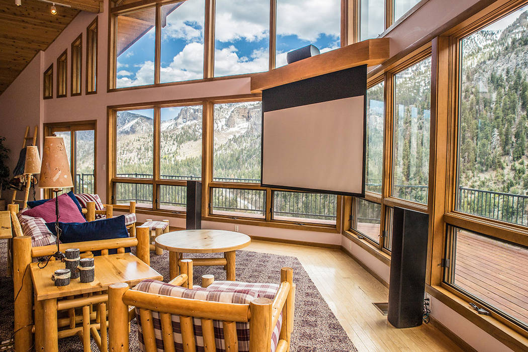 The living room has a large window wall for view the forest. (Tonya Harvey Real Estate Millions)