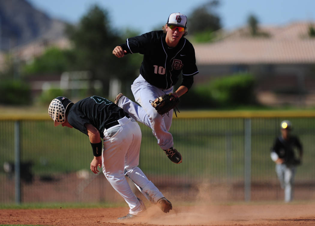 Palo Verde base runner Dylan Orlando (4) interferes with Desert Oasis shortstop Bryson Stott ...