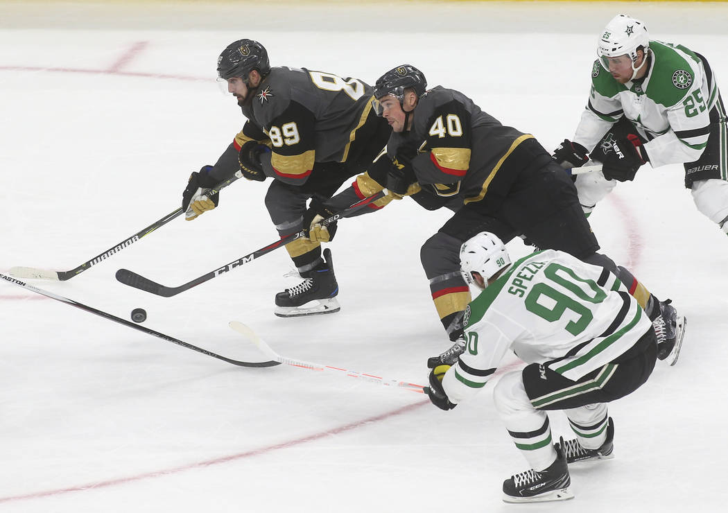 Golden Knights center Ryan Carpenter (40) skates with the puck alongside right wing Alex Tuch ( ...
