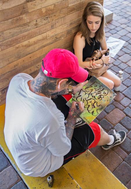 Brandon Morgan, left, with fiancee Danielle Brankin, sketches a memorial message for Max Garcia ...