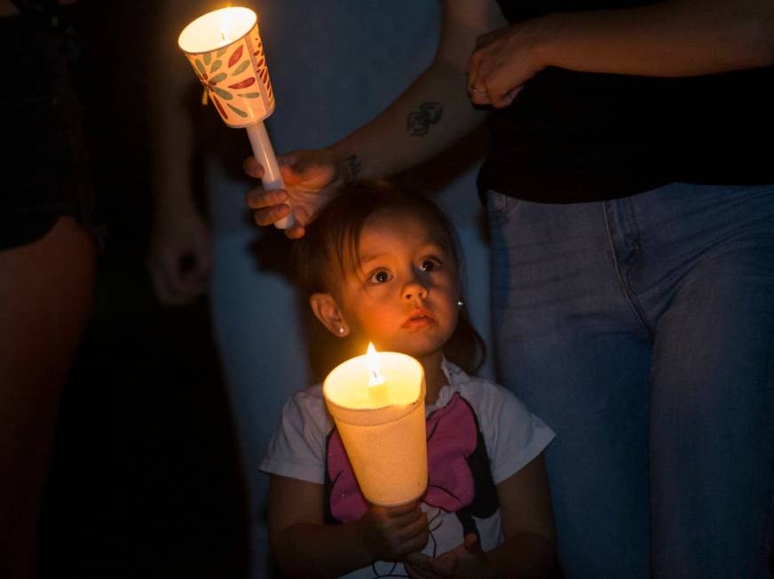 Ripley Rose Garcia, 2, holds a candle during a vigil for her father Max Garcia on Monday, July ...