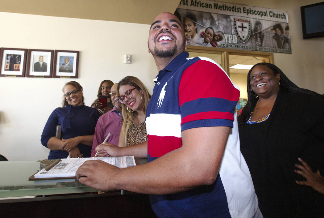 Jovan Jackson, 27, registers to vote with the help of Emily Zamora, left, of Silver State Voice ...