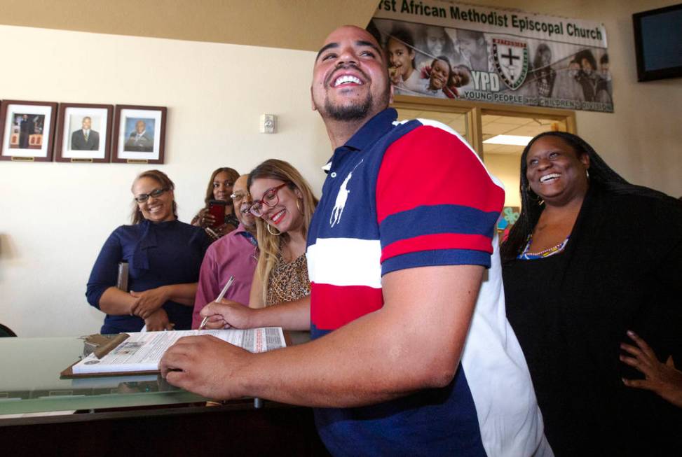 Jovan Jackson, 27, registers to vote with the help of Emily Zamora, left, of Silver State Voice ...