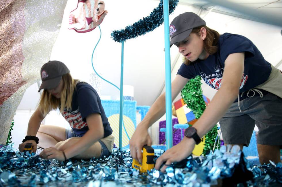 Jordyn Doyle, left, and Noah Jordan work on the "Undersea Jubilee" float during a media preview ...