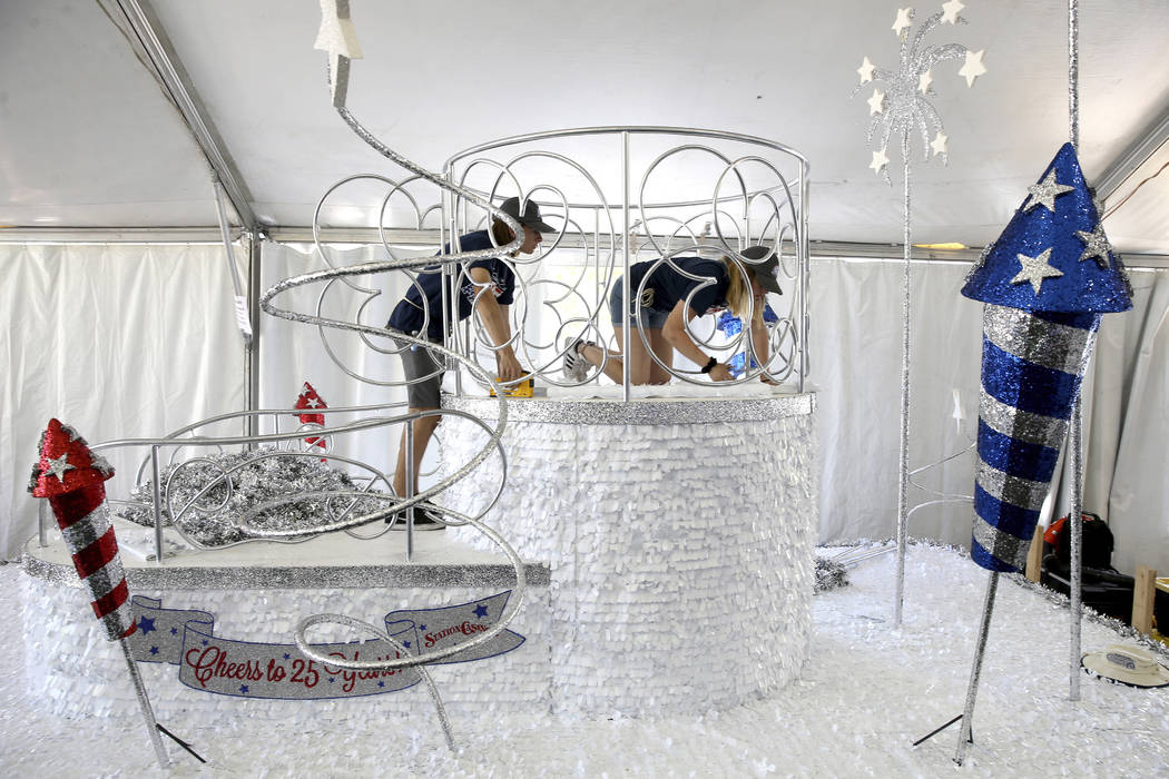 Noah Jordan, left, and Jordyn Doyle work on the “Cheers to 25 Years” float during ...